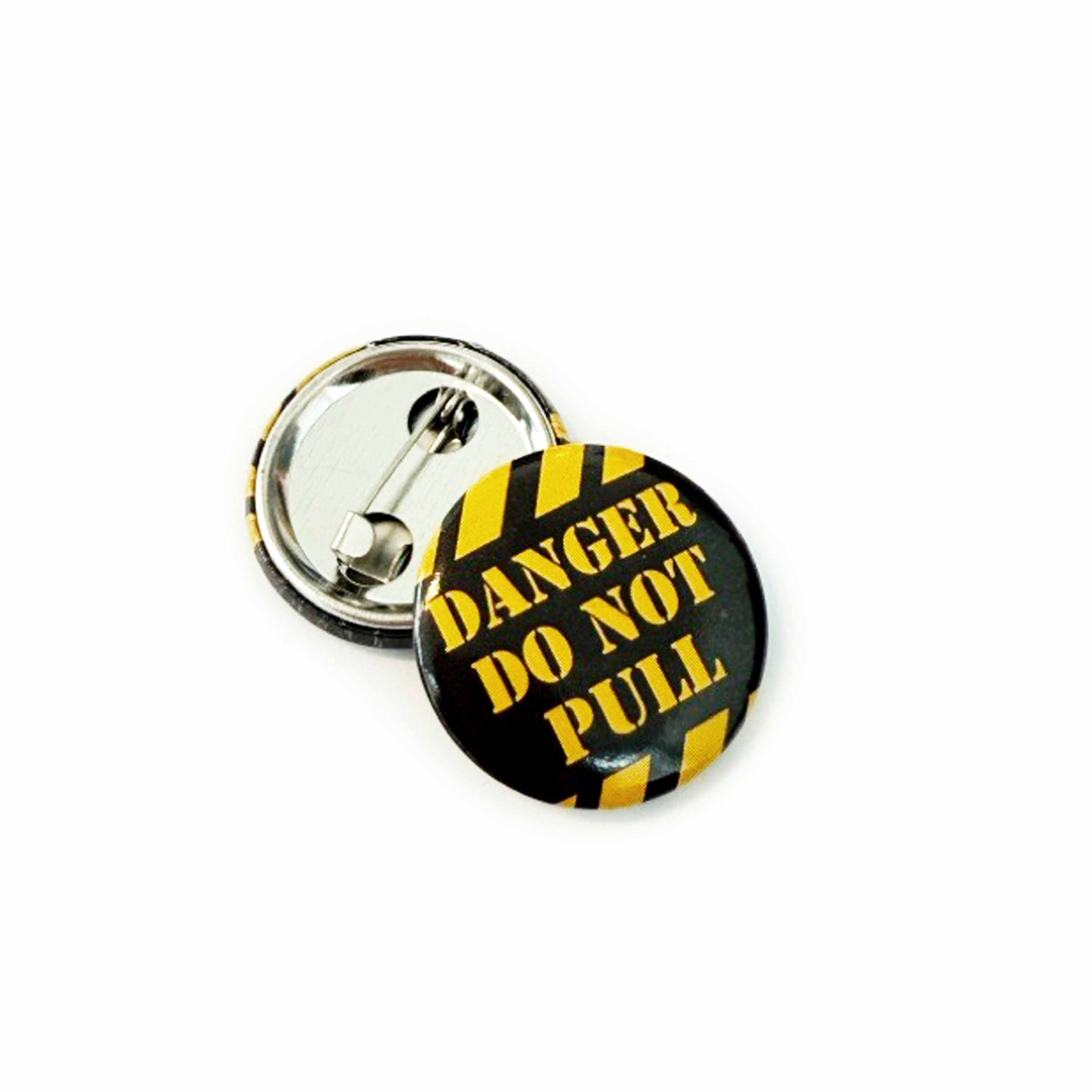 25mm Button badge with 'Danger Do Not Pull' text on a yellow and black striped background