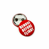 25mm red button badge featuring 'Remove Before Flight' text.