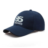 Navy baseball cap with embroidered Battle of Britain 85th Anniversary logo on the front.