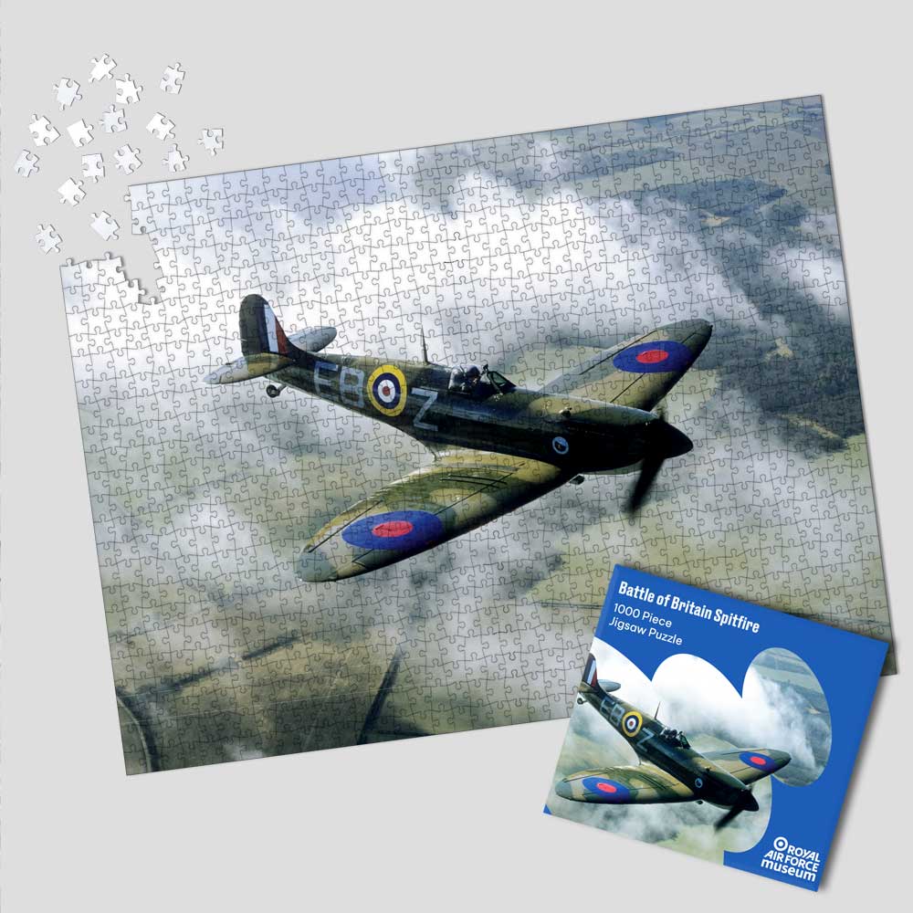 Exclusive to the Royal Air Force Museum. 1000 piece Battle of Britain Spitfire Jigsaw Puzzle featuring a Spitfire aircraft flying above the clouds.