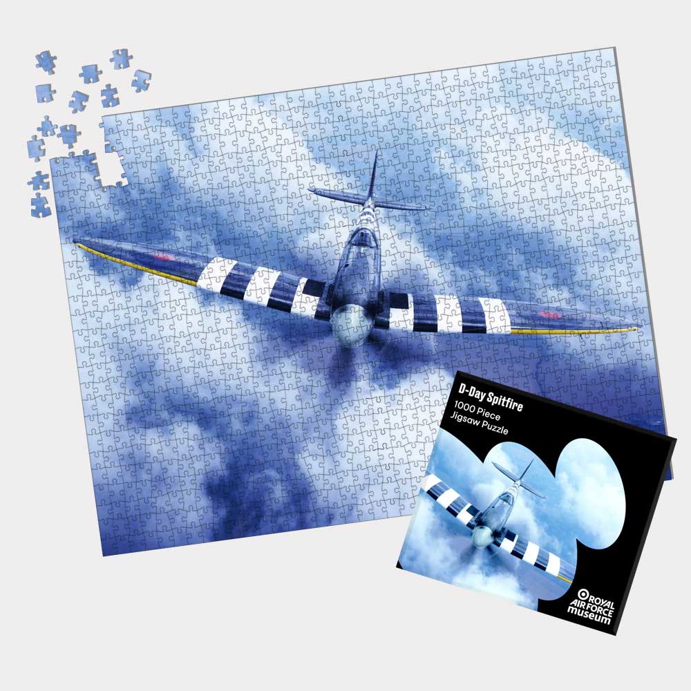 Exclusive to the Royal Air Force Museum. 1,000 piece D-Day Spitfire Jigsaw Puzzle featuring a Spitfire aircraft flying above the clouds.