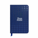 A Navy A6 notebook with an all-over Spitfire pattern with a premium spot gloss varnish finish, featuring a hard PU cover, elastic closure, ribbon page marker, and 96 lined pages.