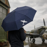 Navy blue folding umbrella featuring a white Spitfire silhouette, with a compact black handle and wrist strap.