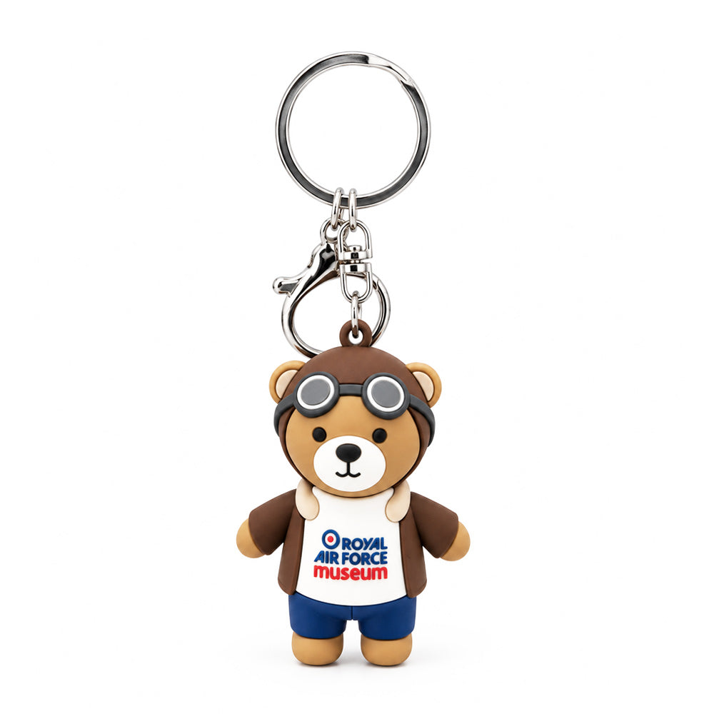 3D PVC pilot bear keyring wearing a brown flying jacket, helmet and goggles, with blue trousers and an RAF Museum logo on its white top.