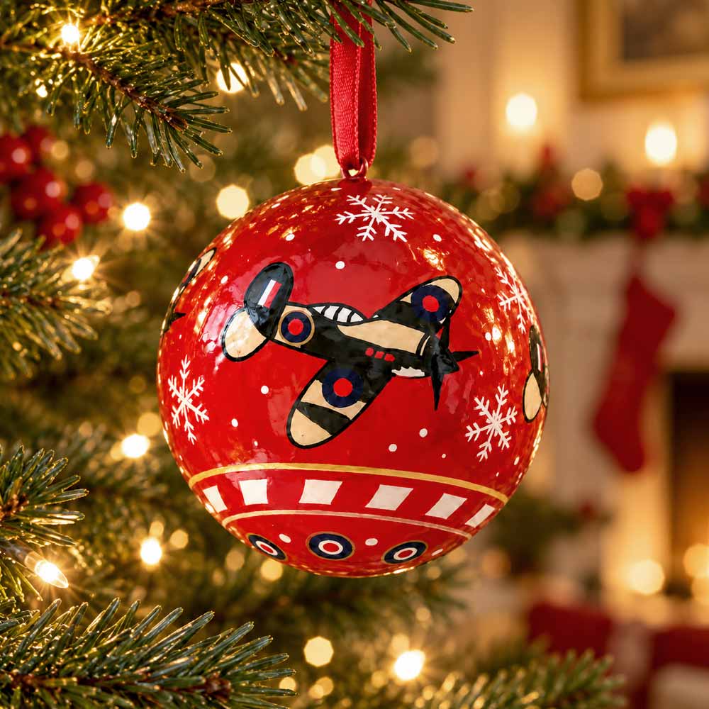 A fair trade hand painted, papier-mâché bauble designed exclusively for the Royal Air Force Museum. It features three Spitfires flying around, RAF roundels and white snowflakes,