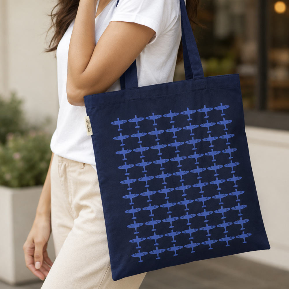 Navy recycled cotton tote bag with long handles, featuring a repeated blue Spitfire silhouette pattern across the front.