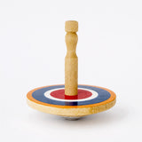 Natural wood spinning top with bright Roundel design, handcrafted in Sri Lanka from eco-friendly alstonia wood, 55mm diameter. Suitable for ages 3+.