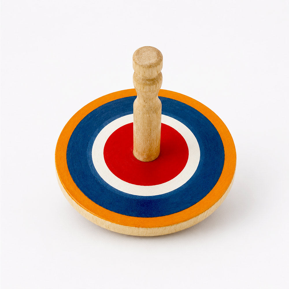 Natural wood spinning top with bright Roundel design, handcrafted in Sri Lanka from eco-friendly alstonia wood, 55mm diameter. Suitable for ages 3+.